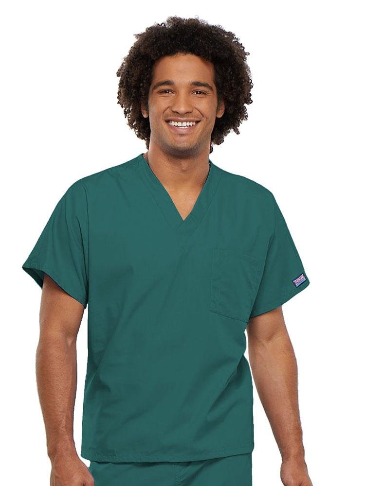 A young male Veterinarian wearing a Cherokee Workwear Originals Unisex Single Pocket V-neck Scrub Top in Teal size 4XL featuring short sleeves.