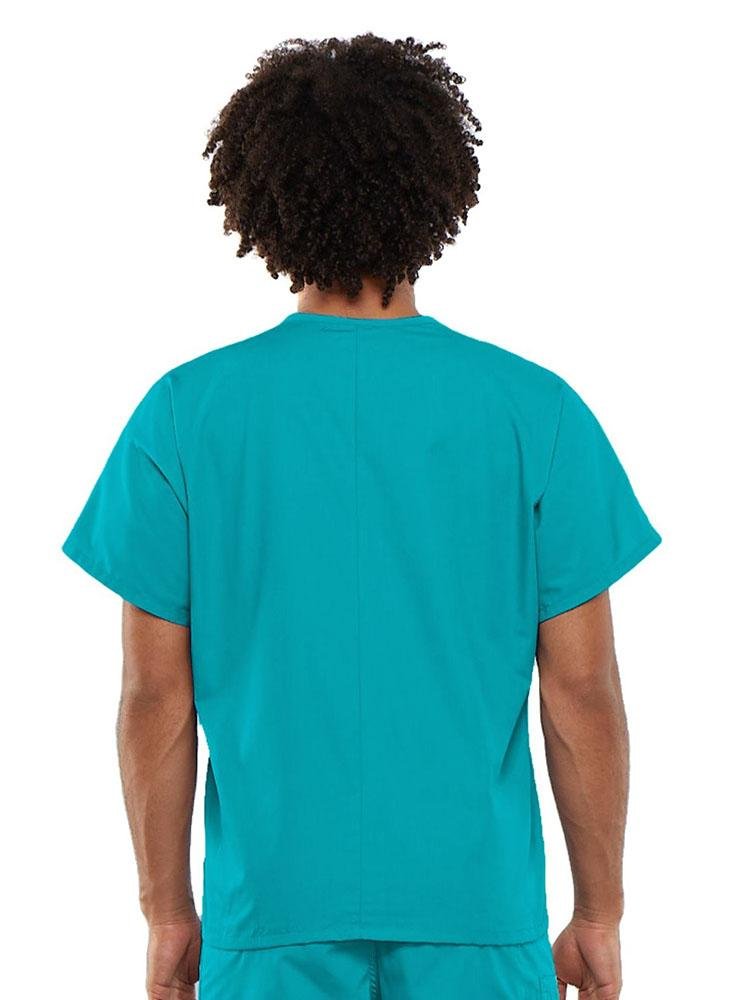 A young male Occupational Therapist wearing a Cherokee Workwear Originals Unisex Single Pocket V-neck Scrub Top in Turquoise size Large featuring a center back length of 27.5".