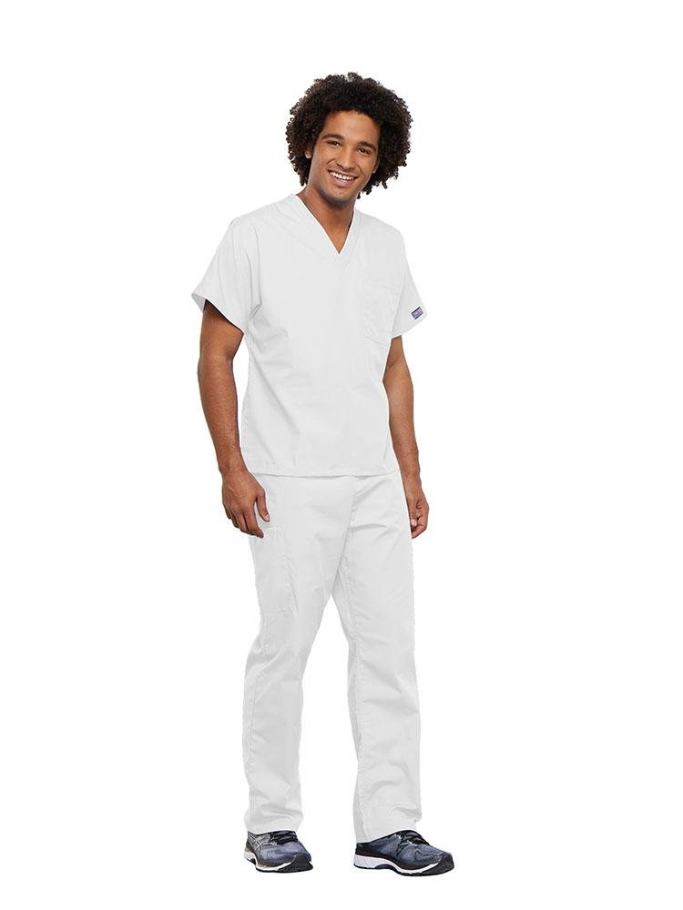 A young male Dietician wearing a Cherokee Workwear Originals Unisex Single Pocket V-neck Scrub Top in White size Large featuring a center back length of 27.5".