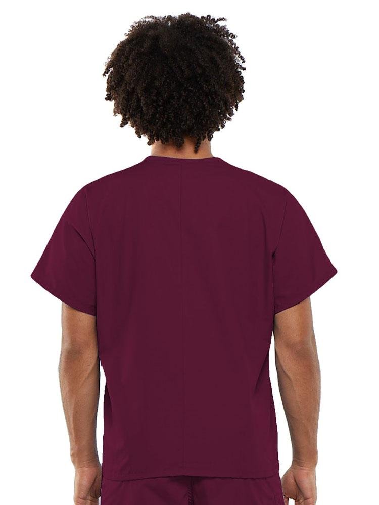 A young male Clinical Laboratory Technician wearing a Cherokee Workwear Originals Unisex Single Pocket V-neck Scrub Top in Wine size Large featuring a center back length of 27.5".