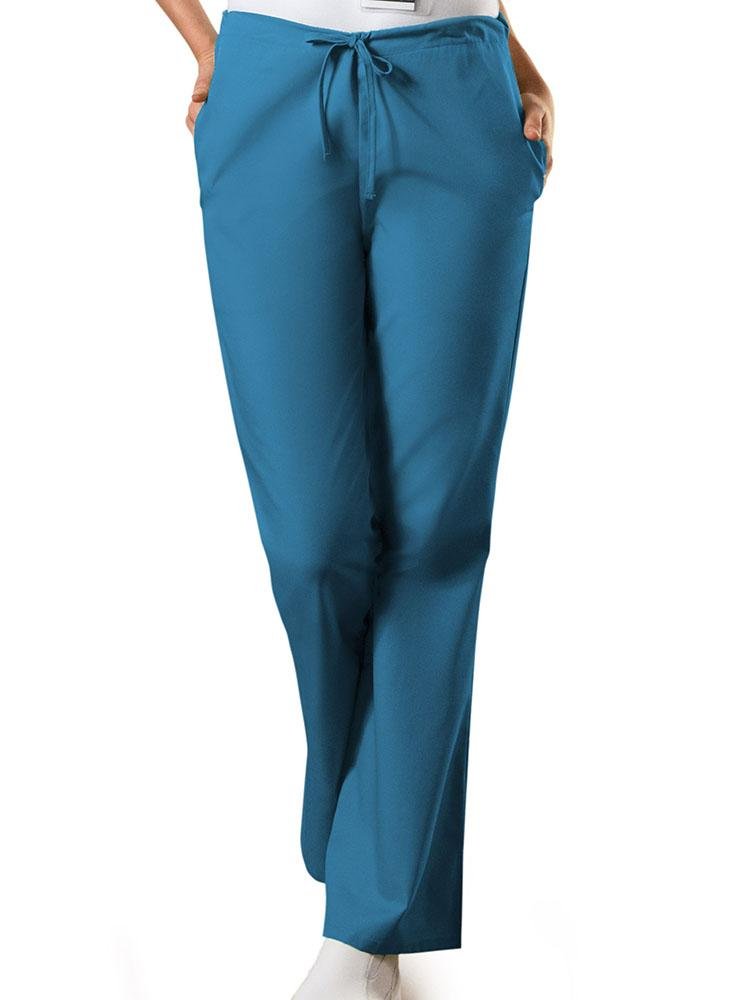 A young female Medical Assistant wearing a Cherokee Workwear Originals Women's Drawstring Flare Leg Scrub Pant in Caribbean size XS Petite featuring an adjustable drawstring waist.