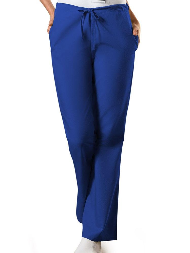 A young female Medical Assistant wearing a Cherokee Workwear Originals Women's Drawstring Flare Leg Scrub Pant in Galaxy Blue size Large Petite featuring an adjustable drawstring waist.
