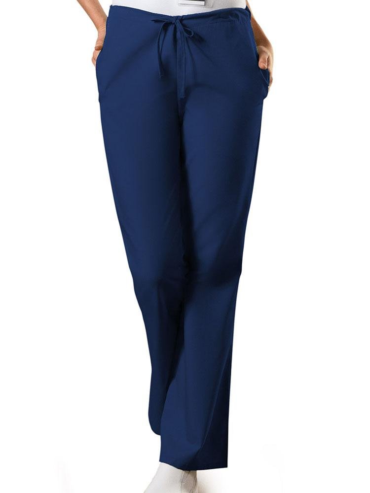 A young female Nursing Assistant wearing a Cherokee Workwear Originals Women's Drawstring Flare Leg Scrub Pant in Navy size Large featuring a Modern Classic fit.