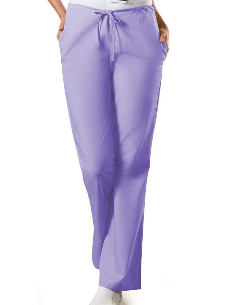 A young female LPN wearing a Cherokee Workwear Originals Women's Drawstring Flare Leg Scrub Pant in Orchid size Small Tall featuring a Modern Classic fit.