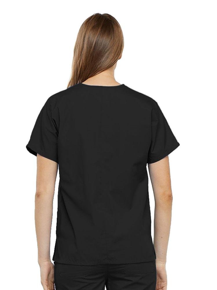 A young female LPN wearing a Cherokee Workwear Originals Women's V-neck Scrub Top in Black size medium featuring a center back length of 26.5".