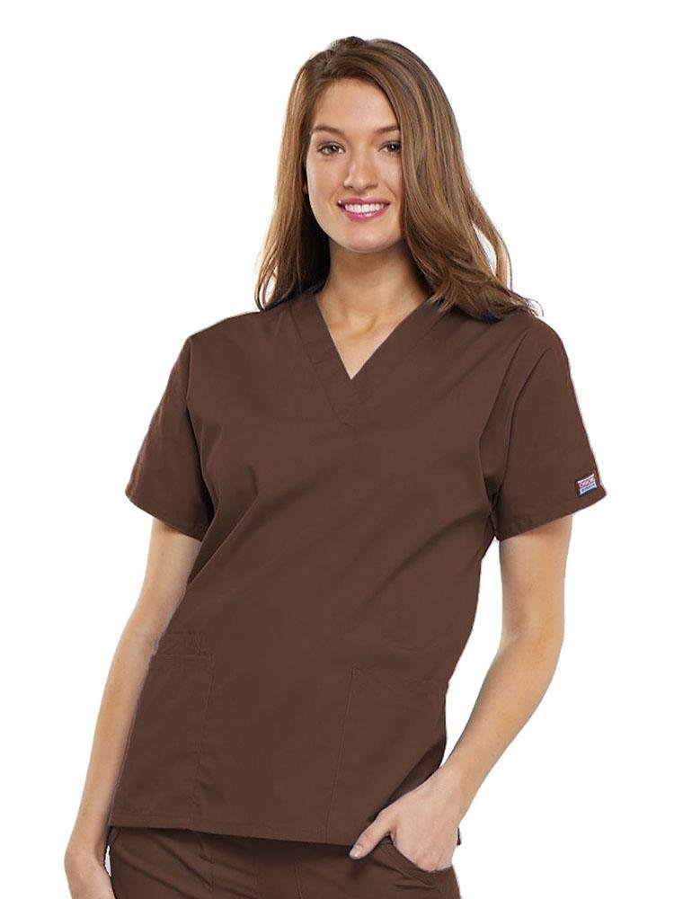 A young female Registered Nurse wearing a Cherokee Workwear Originals Women's V-neck Scrub Top in Chocolate size XL featuring short sleeves.