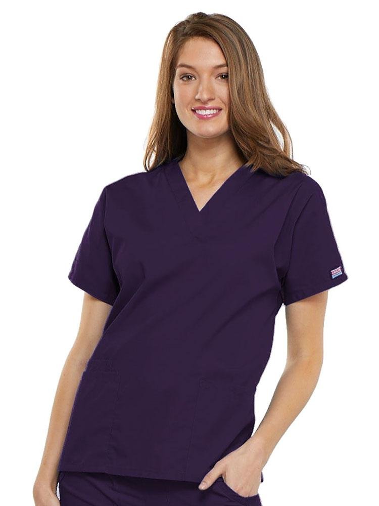 A young female EMT wearing a Cherokee Workwear Originals Women's V-neck Scrub Top in Eggplant size 3XL featuring short sleeves.