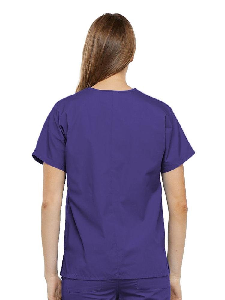 A young female Physician's Assistant wearing a Cherokee Workwear Originals Women's V-neck Scrub Top in Grape size medium featuring a center back length of 26.5".