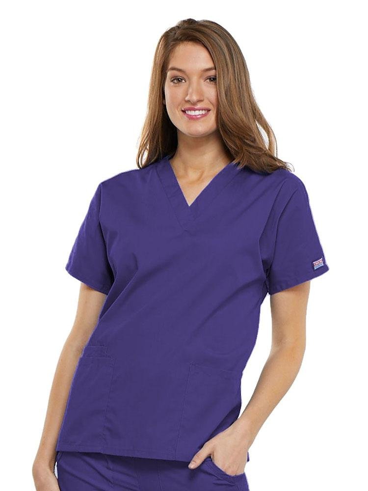 A young female EMT wearing a Cherokee Workwear Originals Women's V-neck Scrub Top in Grape size 3XL featuring short sleeves.