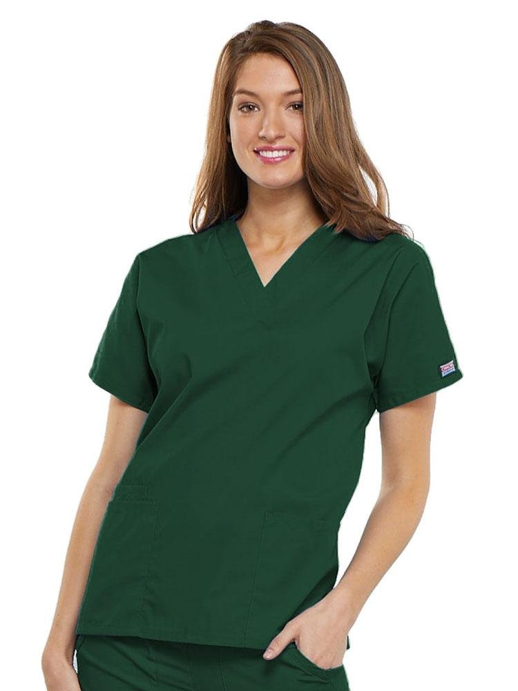 A young female Family Practitioner wearing a Cherokee Workwear Originals Women's V-neck Scrub Top in Hunter Green size 2XL featuring short sleeves.