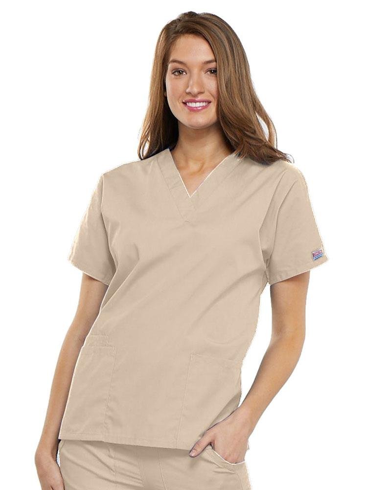 A young female EMT wearing a Cherokee Workwear Originals Women's V-neck Scrub Top in Khaki size 3XL featuring short sleeves.