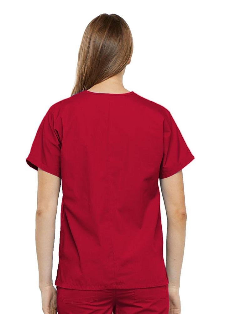 A young female Surgical Technologist wearing a Cherokee Workwear Originals Women's V-neck Scrub Top in Red size 2XL featuring a center back length of 26.5".