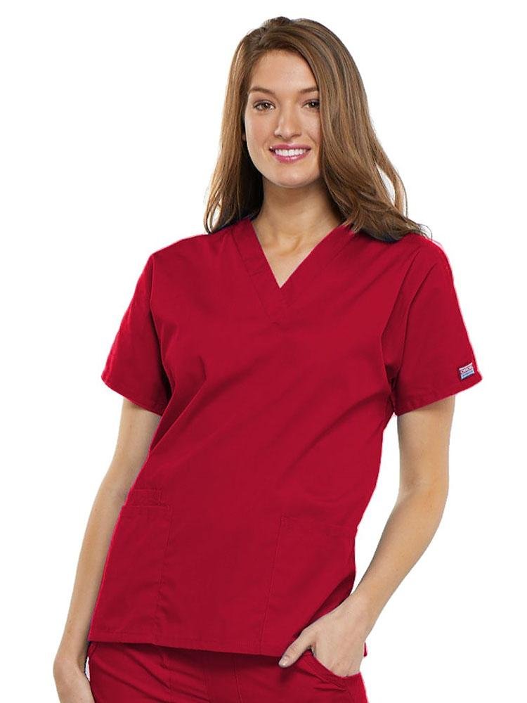 A young female Family Practitioner wearing a Cherokee Workwear Originals Women's V-neck Scrub Top in Red size 2XL featuring short sleeves.