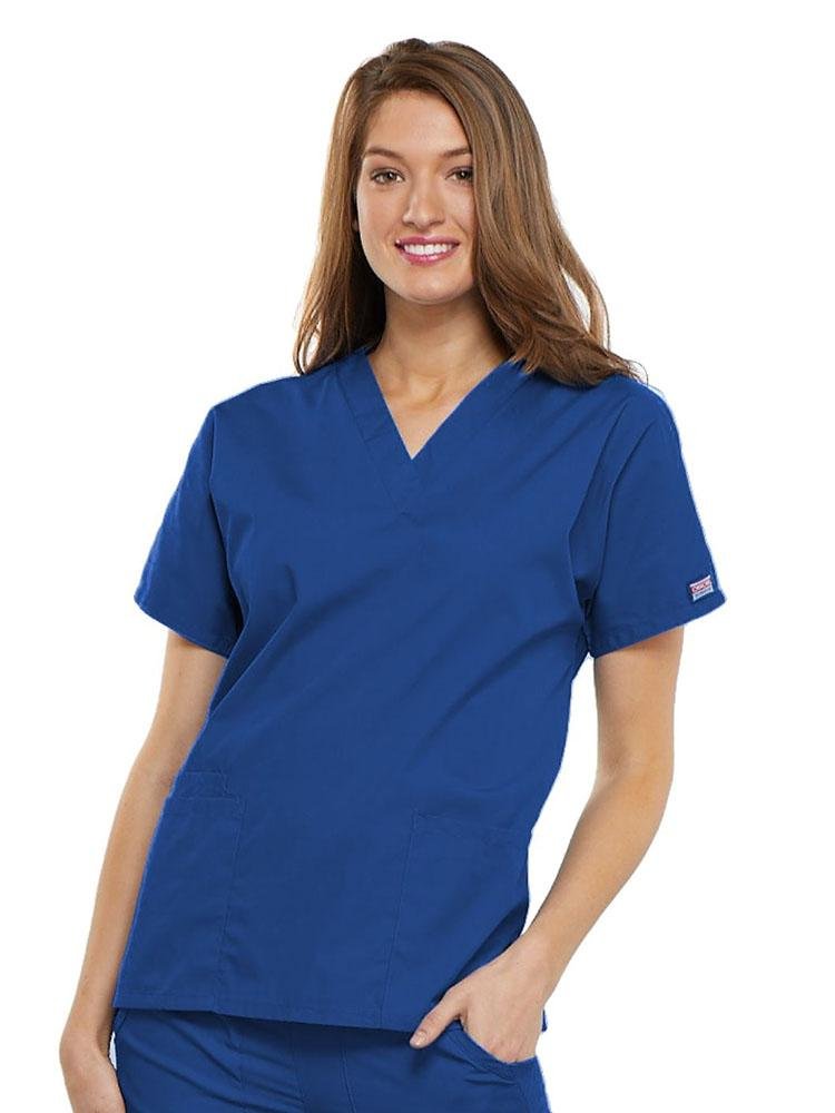 A young female EMT wearing a Cherokee Workwear Originals Women's V-neck Scrub Top in Royal size 3XL featuring short sleeves.