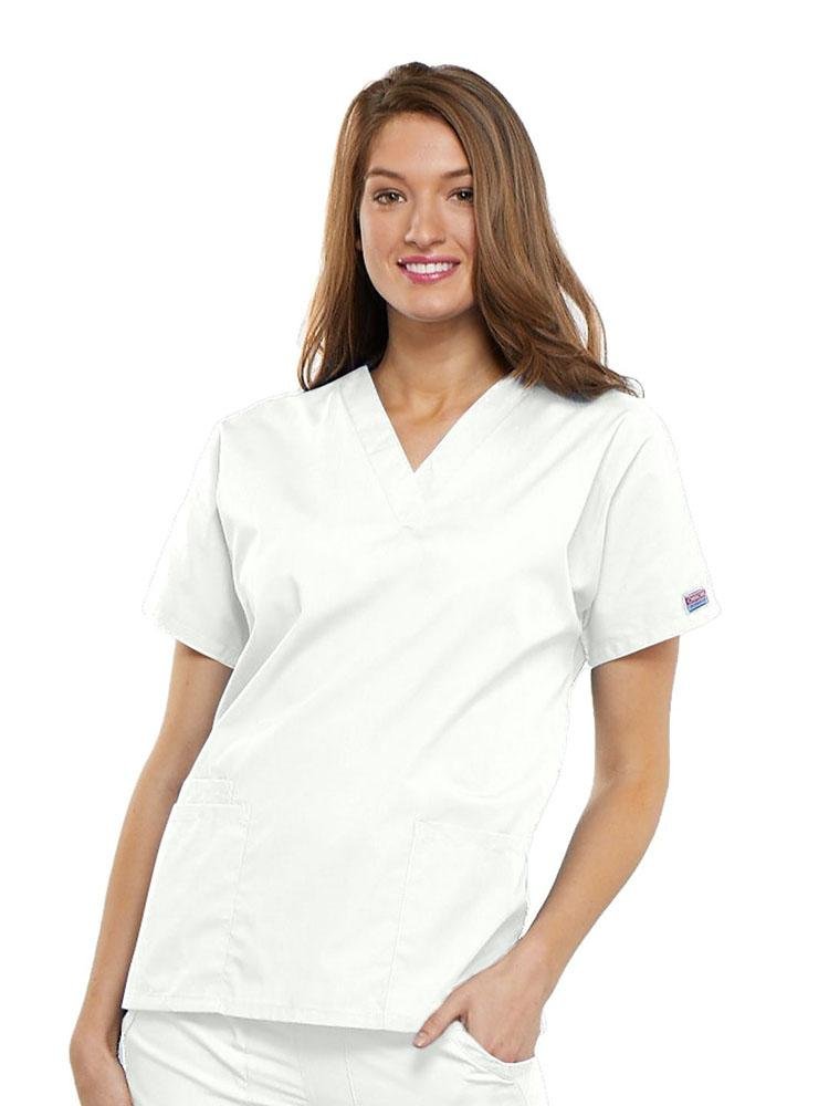 A young female Family Practitioner wearing a Cherokee Workwear Originals Women's V-neck Scrub Top in White size 2XL featuring short sleeves.