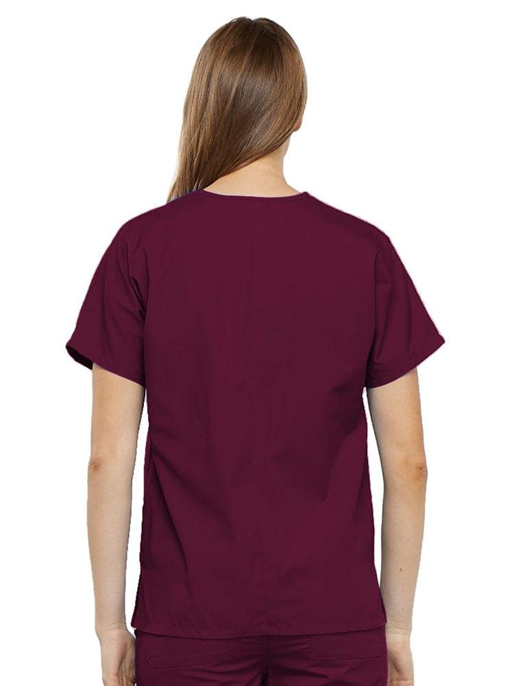 A young female LPN wearing a Cherokee Workwear Originals Women's V-neck Scrub Top in Wine size medium featuring a center back length of 26.5".