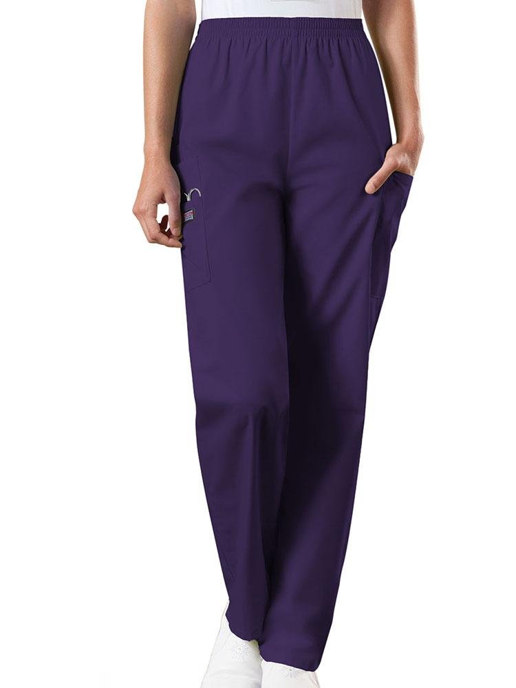A young female Emergency Medical Technician wearing a Cherokee Workwear Originals Women's Natural Rise Tapered Pull-On Scrub Pant in Eggplant size Large Petite featuring an elastic waist.