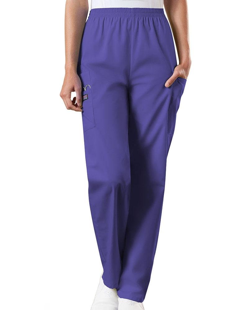 A young female Emergency Medical Technician wearing a Cherokee Workwear Originals Women's Natural Rise Tapered Pull-On Scrub Pant in Grape size 3XL featuring an elastic waist.