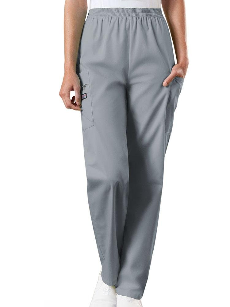 A young female Emergency Medical Technician wearing a Cherokee Workwear Originals Women's Natural Rise Tapered Pull-On Scrub Pant in Grey  size Small Petite featuring an elastic waist.