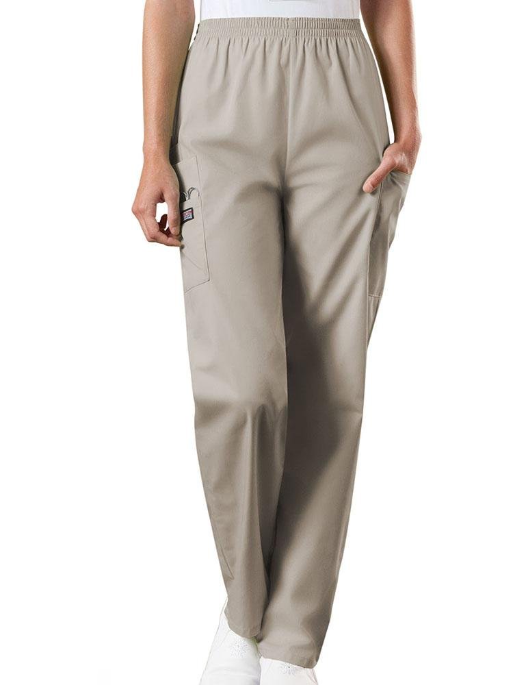 A young female Emergency Medical Technician wearing a Cherokee Workwear Originals Women's Natural Rise Tapered Pull-On Scrub Pant in Khaki size 3XL featuring an elastic waist.