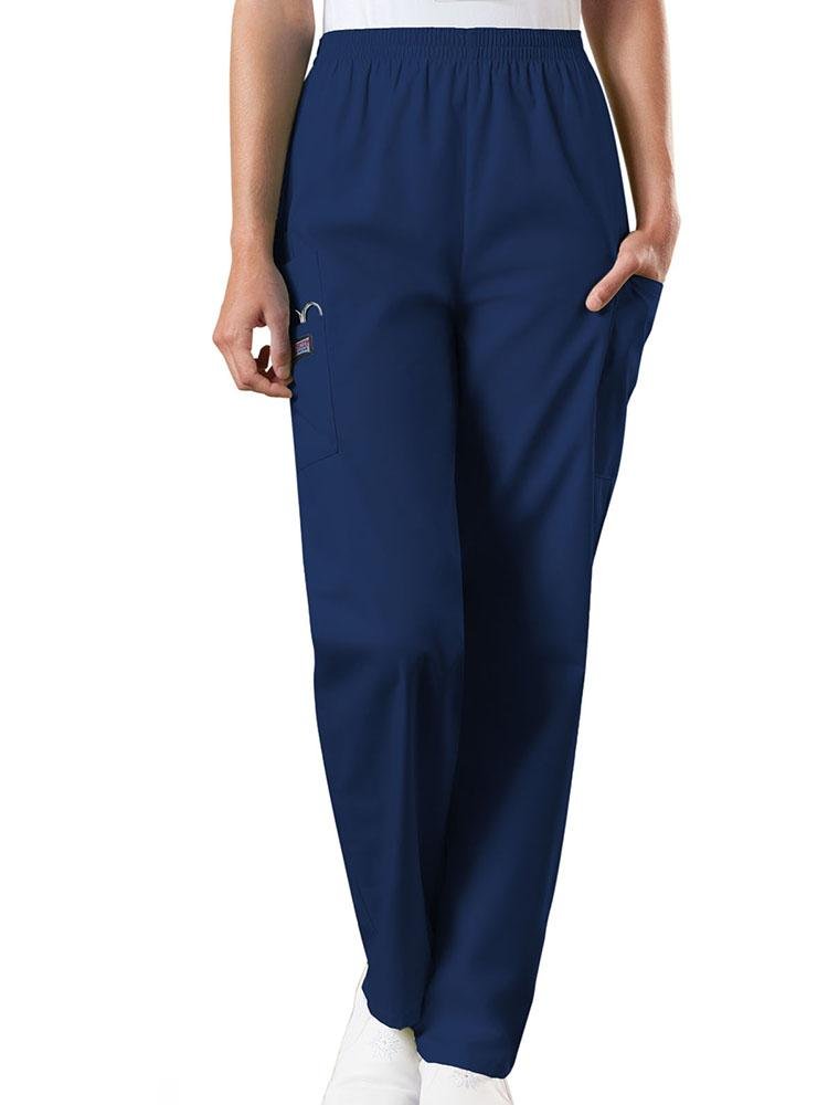 A young female Emergency Medical Technician wearing a Cherokee Workwear Originals Women's Natural Rise Tapered Pull-On Scrub Pant in Navy size Small Petite featuring an elastic waist.