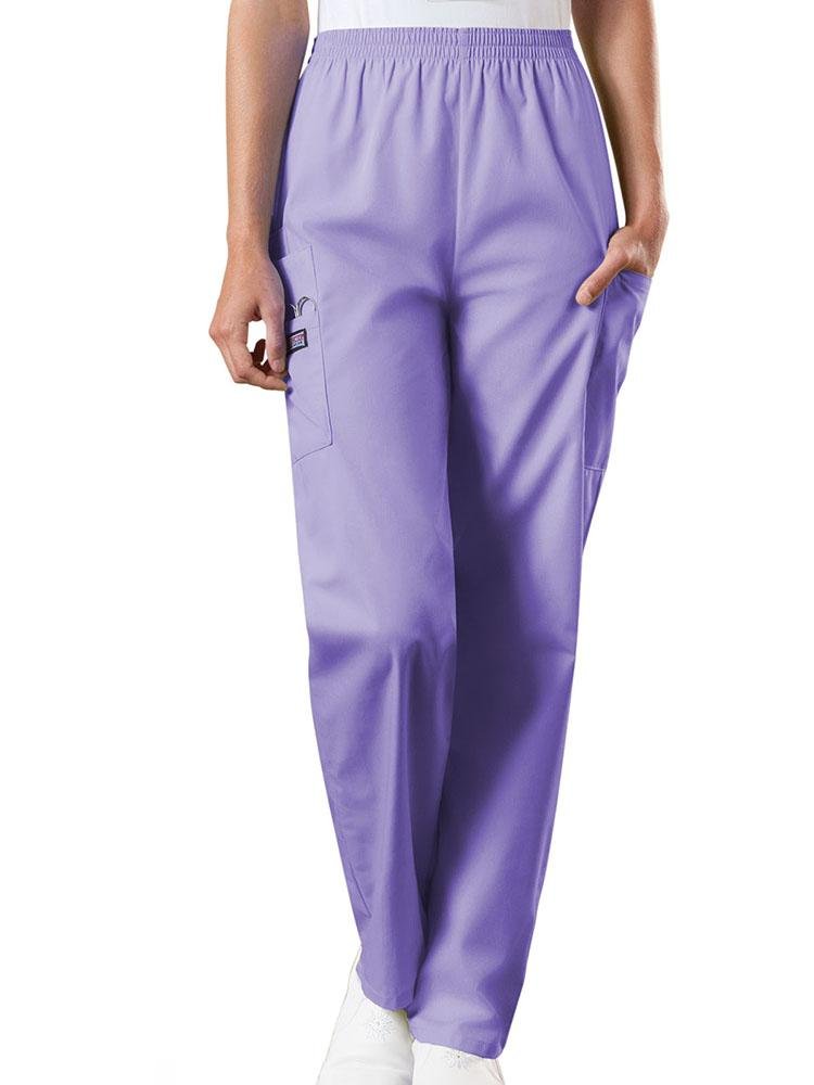 A young female Emergency Medical Technician wearing a Cherokee Workwear Originals Women's Natural Rise Tapered Pull-On Scrub Pant in Orchid size 3XL featuring an elastic waist.