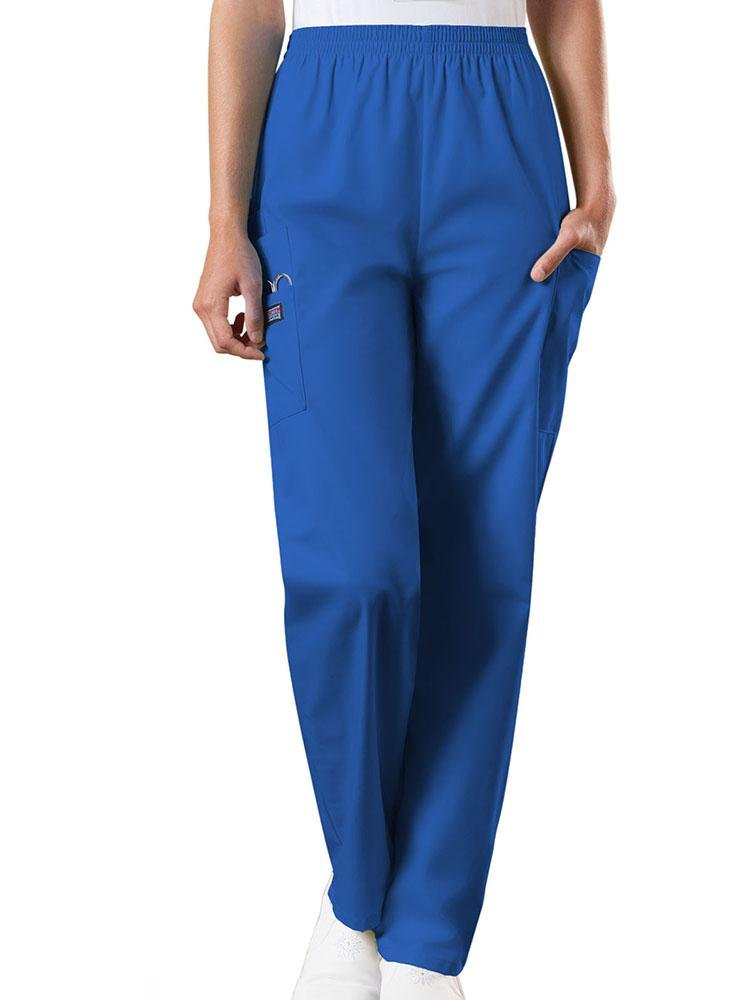 A young female Emergency Medical Technician wearing a Cherokee Workwear Originals Women's Natural Rise Tapered Pull-On Scrub Pant in Royal size Small Petite featuring an elastic waist.