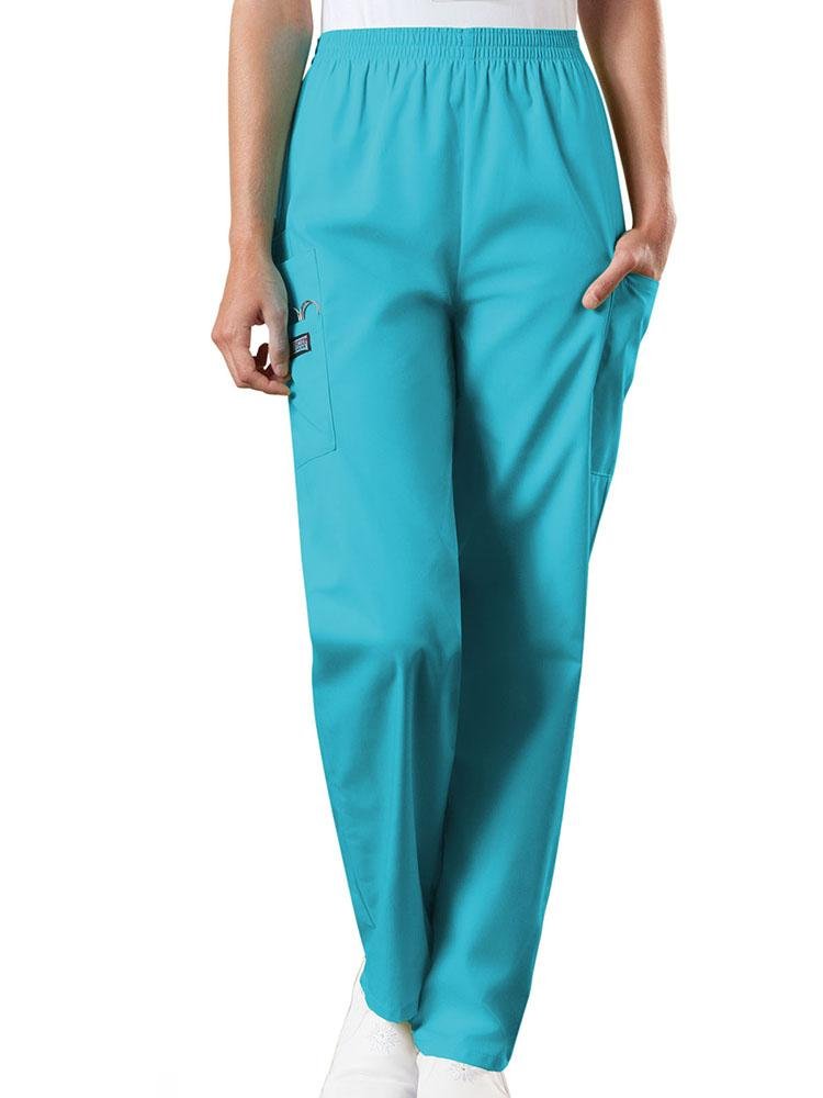 A young female Emergency Medical Technician wearing a Cherokee Workwear Originals Women's Natural Rise Tapered Pull-On Scrub Pant in Turquoise size 3XL featuring an elastic waist.