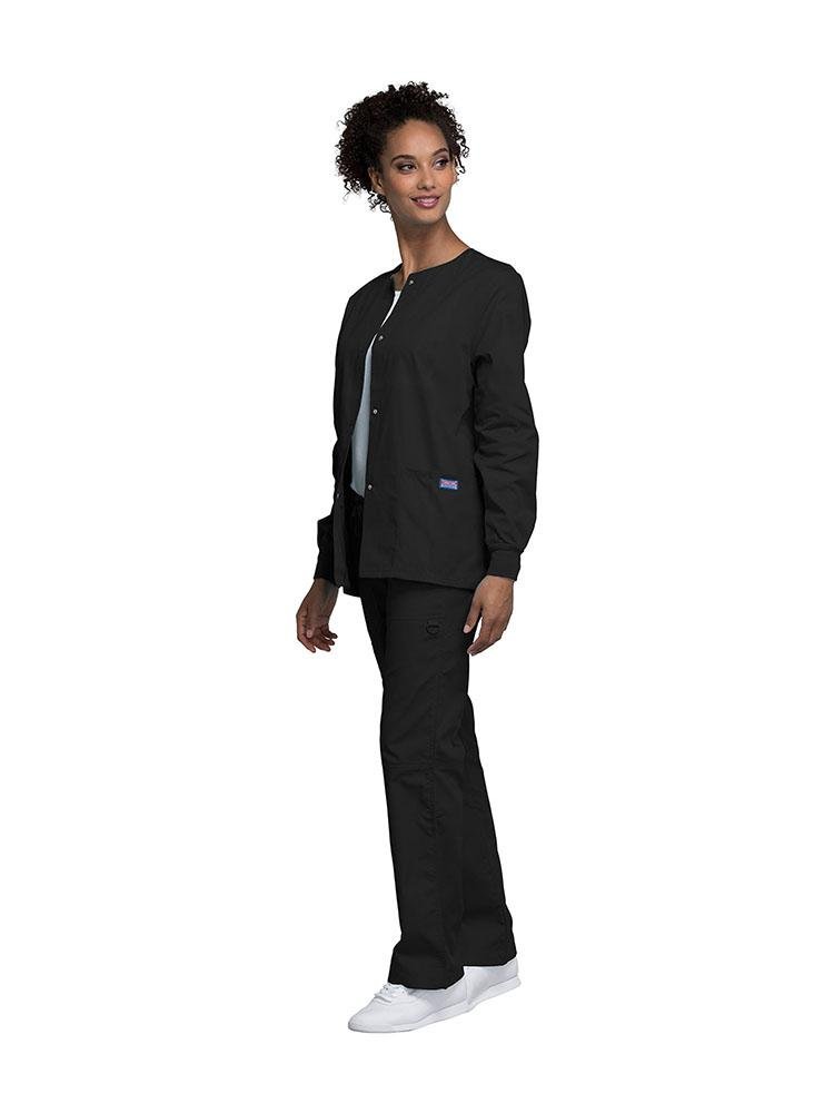 Medical Secretary wearing Cherokee Workwear Originals women's Snap Front Warm-Up Jacket in black size extra small featuring knit cuffs to provide a flattering all day fit.