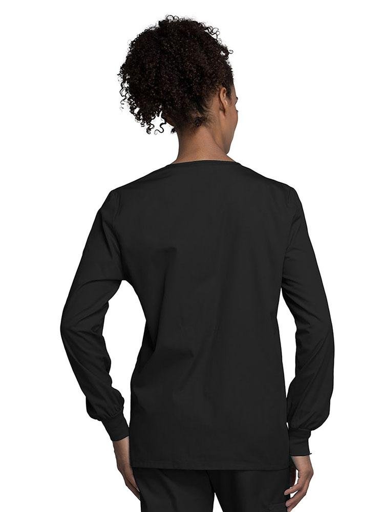 A view of the back of a Cherokee Workwear Originals Women's Snap Front Warm-Up Jacket in Black size Medium with soil release fabric.