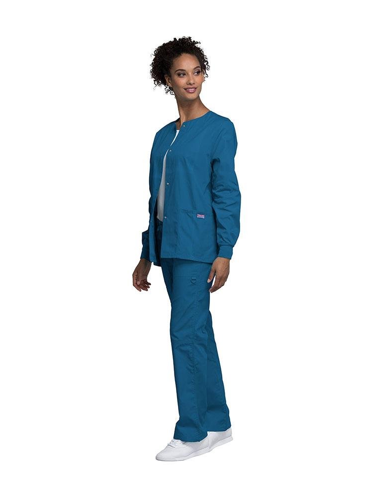 Prosthodontist wearing Cherokee Workwear Originals women's Snap Front Warm-Up Jacket in Caribbean size medium featuring a unique polyester/cotton blend fabric.