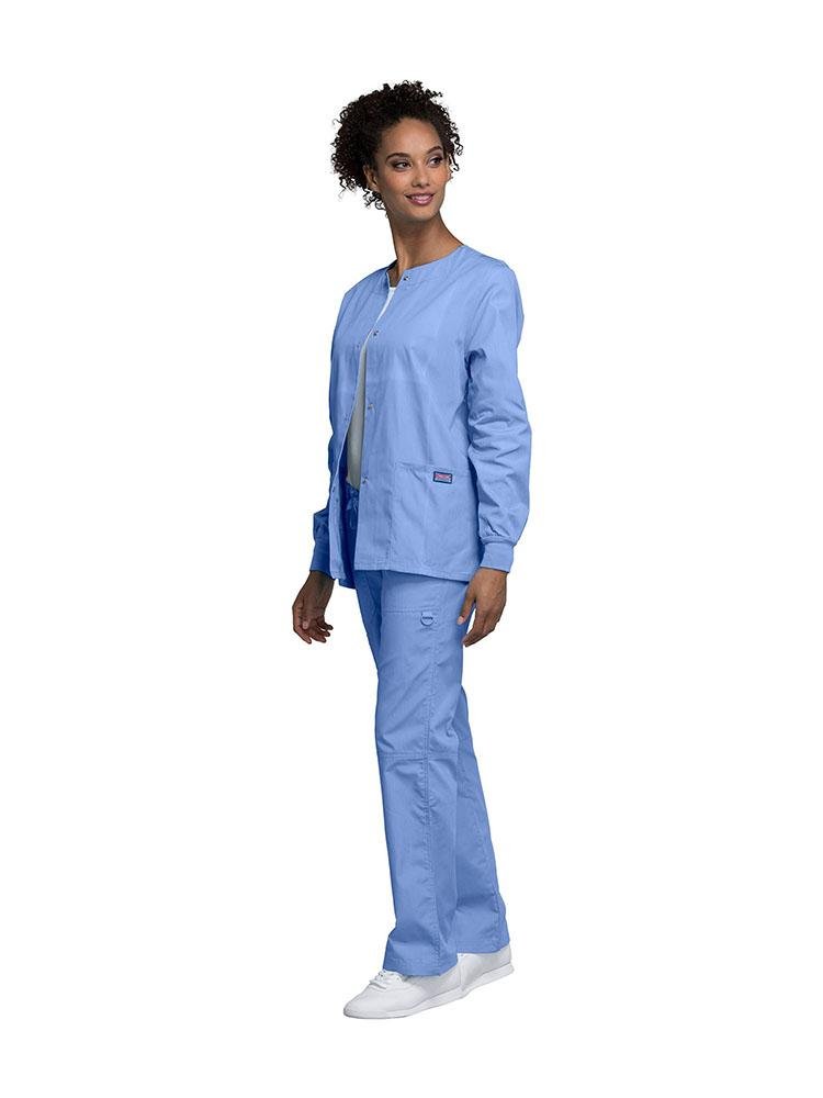 An Oral Surgeon wearing a Cherokee Workwear Originals women's Snap Front Warm-Up Jacket in Ceil size small featuring a traditional classic fit.