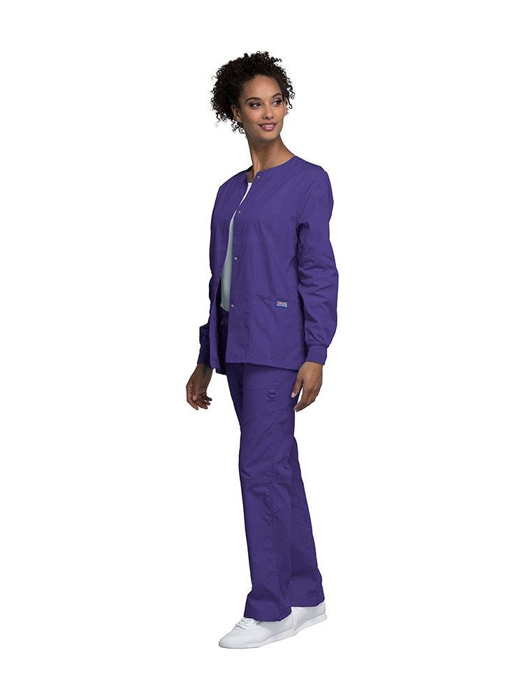 A female Dental Hygienist wearing a Cherokee Workwear Originals women's Snap Front Warm-Up Jacket in grape size extra extra small featuring a unique polyester/cotton blend fabric.