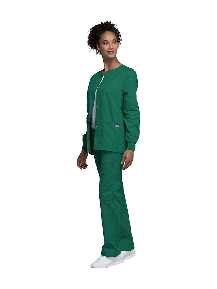 A female Dental Hygienist wearing a Cherokee Workwear Originals women's Snap Front Warm-Up Jacket in Hunter Green size extra extra small featuring a unique polyester/cotton blend fabric.