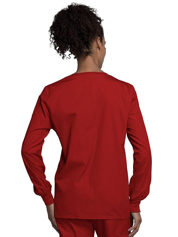 A view of the back of a Cherokee Workwear Originals Women's Snap Front Warm-Up Jacket in Red size Medium with soil release fabric.