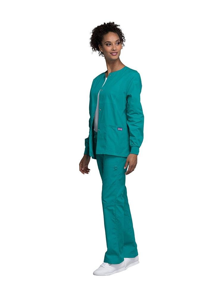 Medical Secretary wearing Cherokee Workwear Originals women's Snap Front Warm-Up Jacket in Teal size extra small featuring knit cuffs to provide a flattering all day fit.
