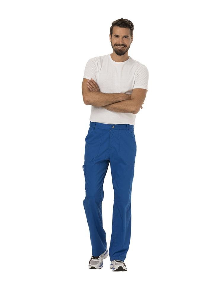 A male caretaker wearing a Cherokee Workwear Revolution Men's Drawstring Cargo Scrub Pant in Royal Blue size Medium featuring a total of 5 pockets.
