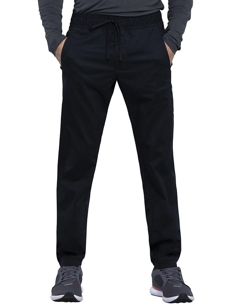 Physical Therapy Assistant wearing Cherokee Workwear Revolution men's Jogger Scrub Pant in black size medium