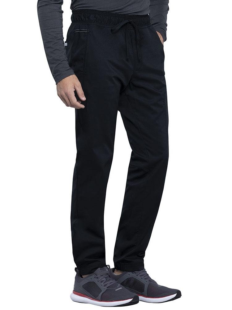 Surgical Technician wearing Cherokee Workwear Revolution men's Jogger Scrub Pant in black size 3X