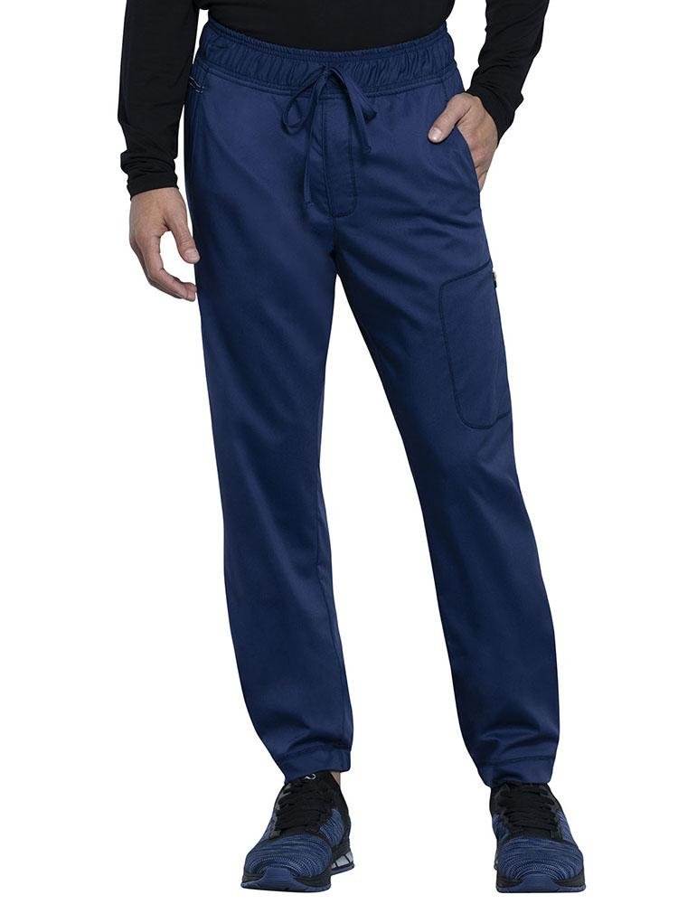 Occupational Therapist wearing Cherokee Workwear Revolution men's Jogger Scrub Pant in navy size extra extra large