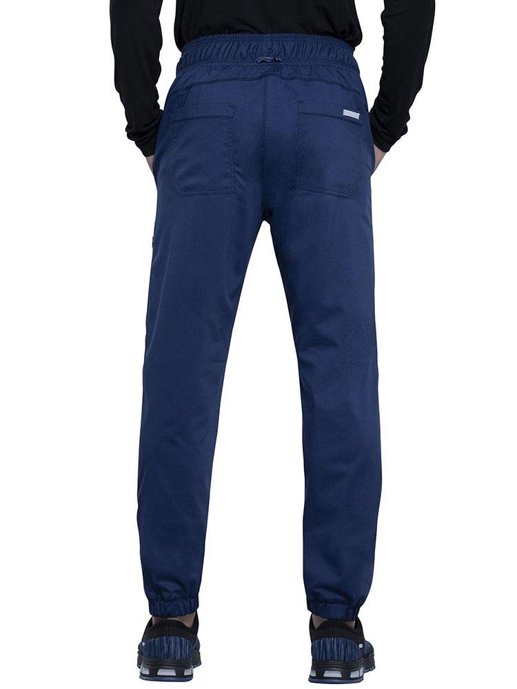 Back view of Pediatrician wearing Cherokee Workwear Revolution men's Jogger Scrub Pant in navy size small