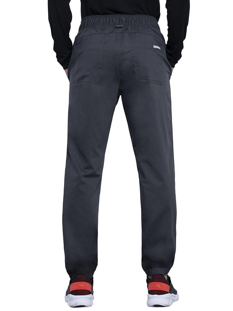 Back view of RN wearing Cherokee Workwear Revolution men's Jogger Scrub Pant in pewter size medium