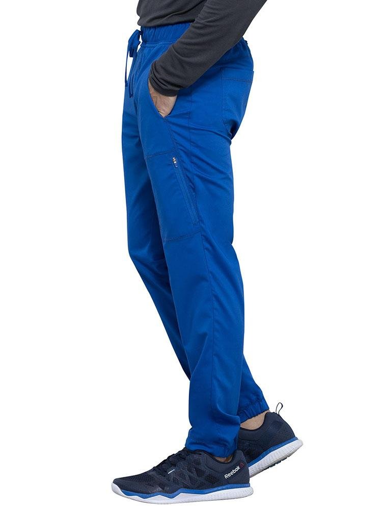 Doctor wearing Cherokee Workwear Revolution men's Jogger Scrub Pant in royal size small
