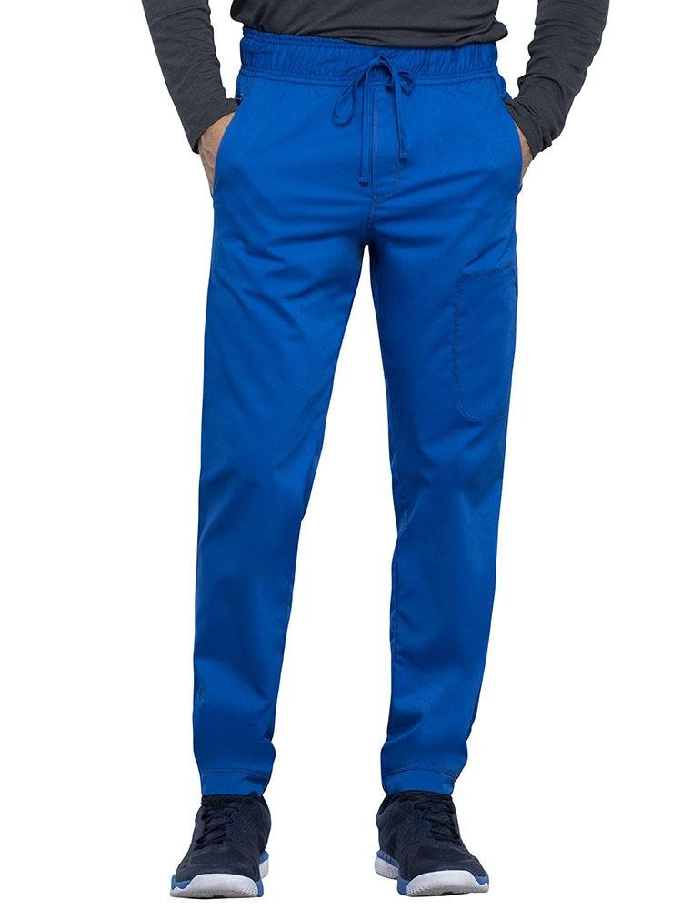 CNA wearing Cherokee Workwear Revolution men's Jogger Scrub Pant in royal size extra large