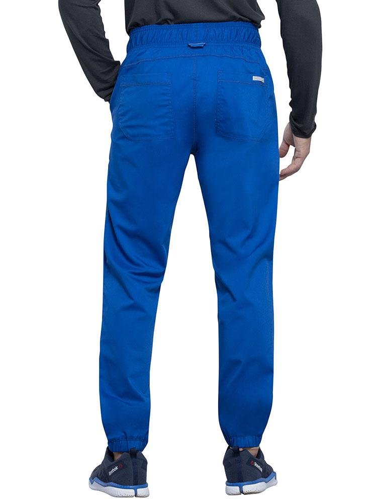 Back view of Nurse Practitioner wearing Cherokee Workwear Revolution men's Jogger Scrub Pant in royal size 2X