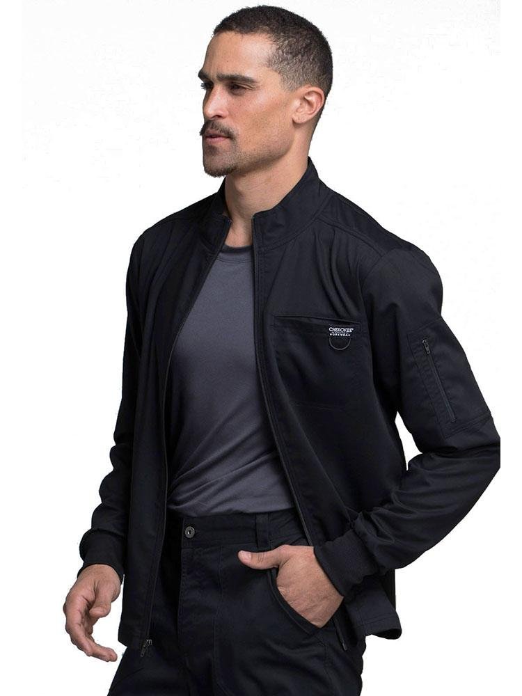 Occupational Therapist Aide wearing Cherokee Workwear Revolution men's Zip Front Scrub Jacket in black size large