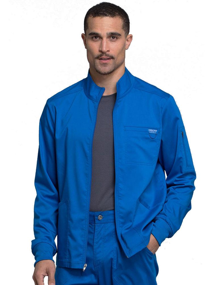 Chiropractor wearing Cherokee Workwear Revolution men's Zip Front Scrub Jacket in royal size extra extra large