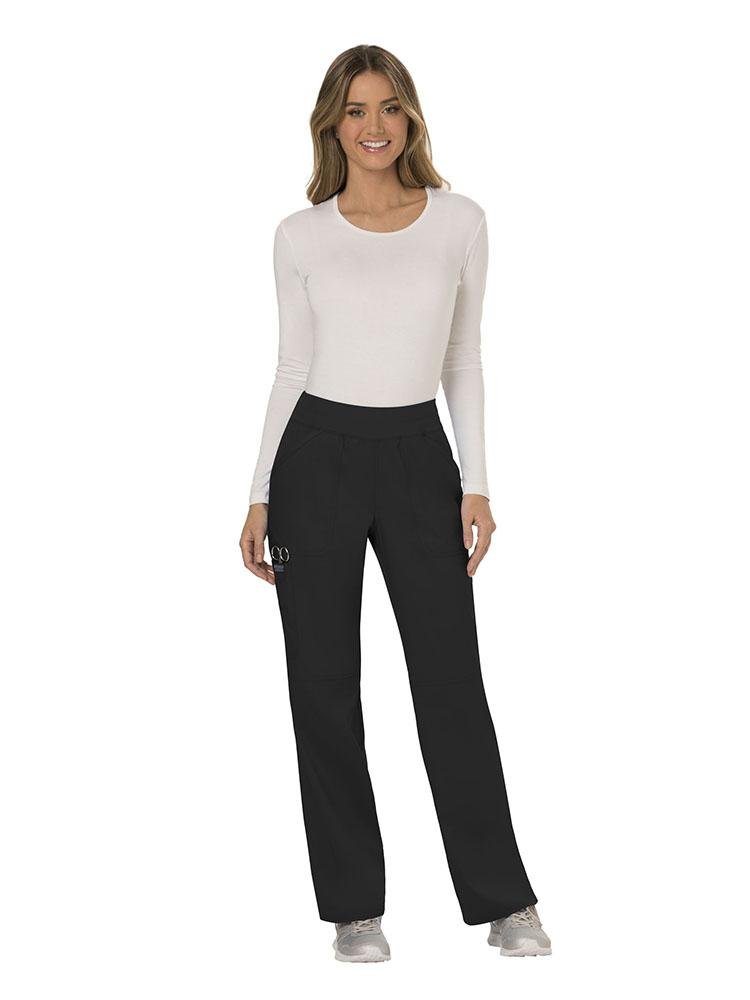 A female LPN wearing Cherokee Workwear Revolution Women's Elastic Waistband Pull-On Scrub Pant in black size small tall featuring an inseam of approximately 34".