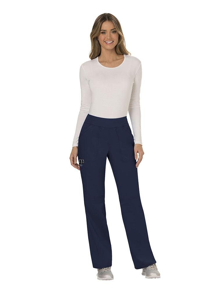A female Physical Therapist wearing Cherokee Workwear Revolution Women's Elastic Waistband Pull-On Scrub Pant in Navy size small tall featuring an inseam of approximately 34".