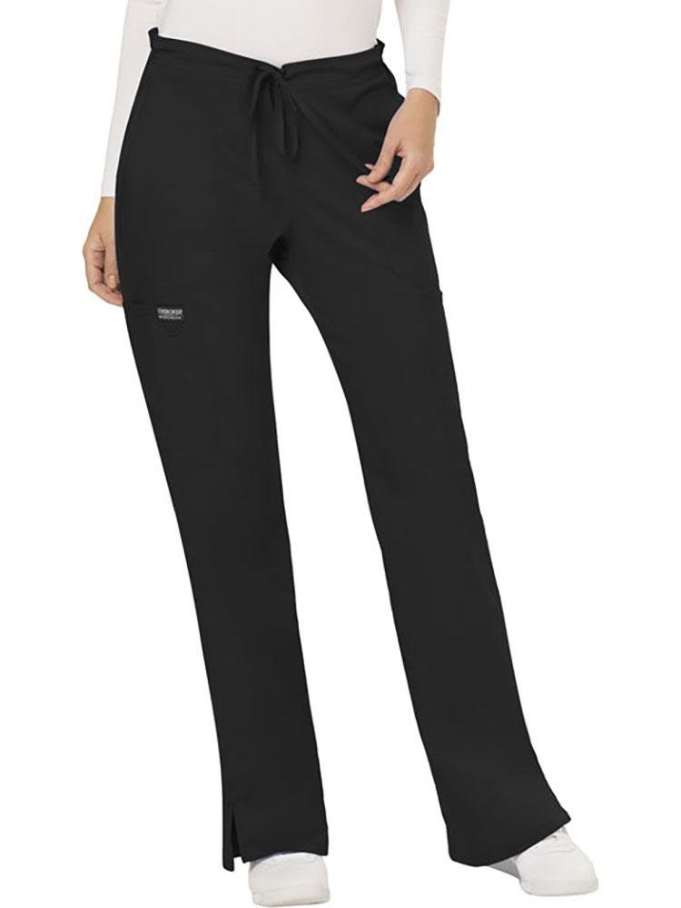 A young female Clinical Laboratory Technician wearing a Cherokee Workwear Revolution Women's Mid Rise Moderate Flare Scrub Pant in Black size XL Petite featuring a drawstring waist to provide a flattering & comfortable all day fit.